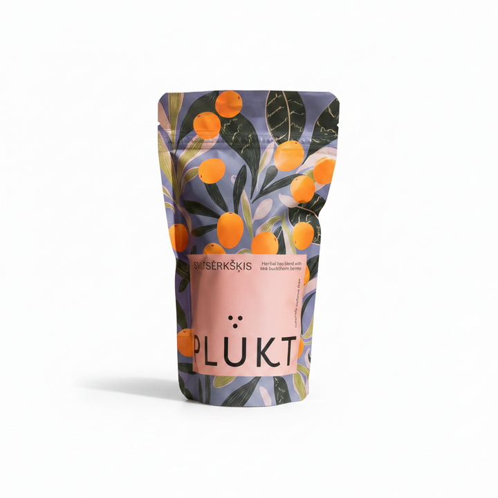 A stand-up pouch of Plukt Bŋsčrāskās (plum leaves and berries) tea, featuring a botanical pattern of orange plums and green leaves on a muted purple background, with a prominent pink label on the front.