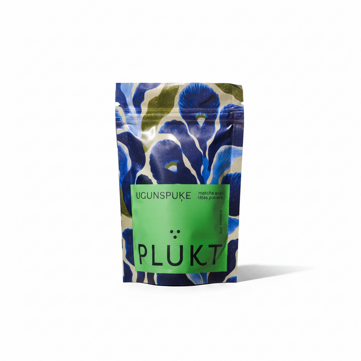A stand-up pouch of Plukt Ugunspuke matcha green tea, featuring a blue and green floral pattern with a prominent green label on a white background.