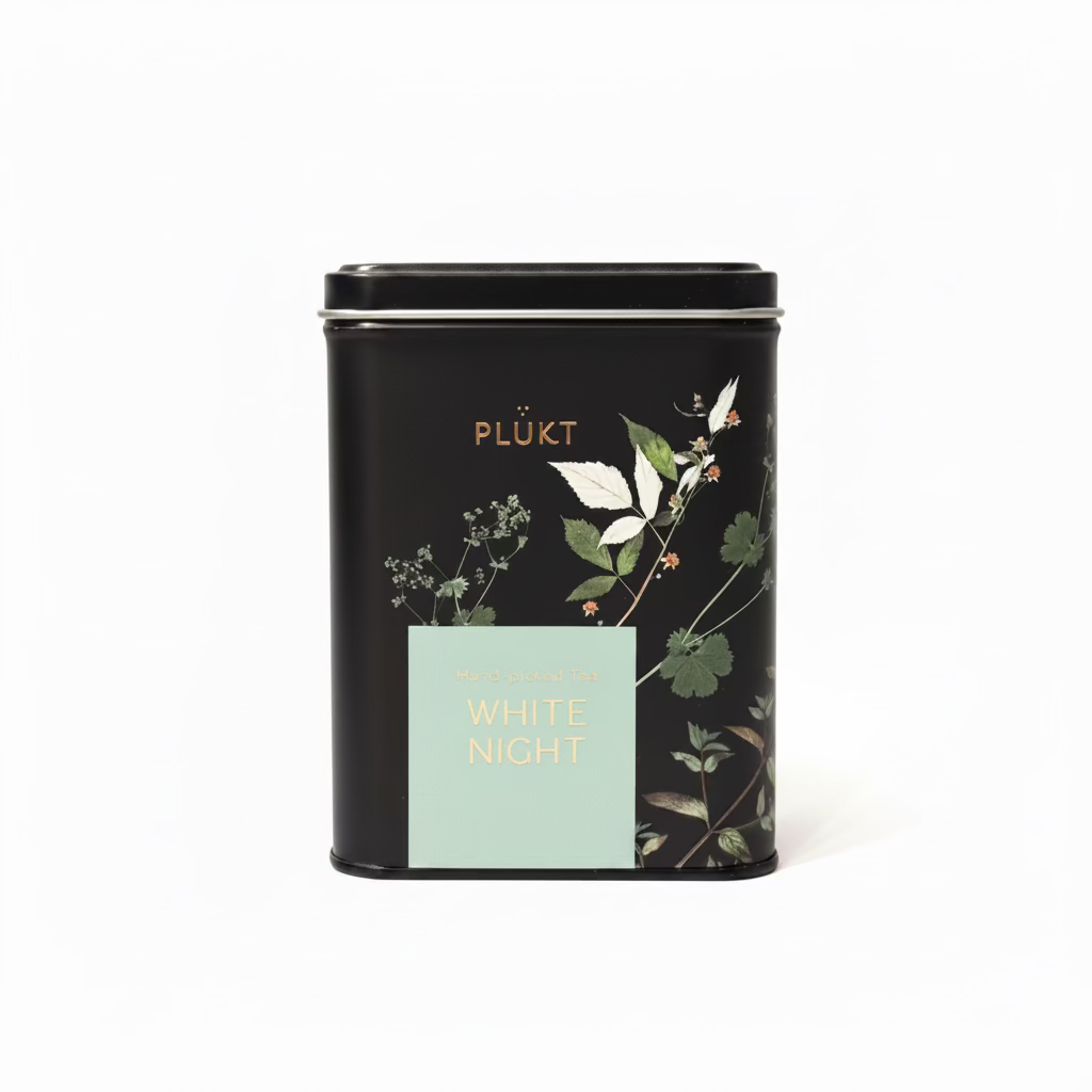 A black metal tea tin with a light blue label reading &
