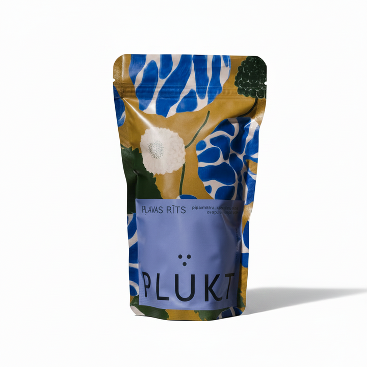 A stand-up pouch package for Plütk Plavas Rits, featuring a colorful pattern of blue, yellow, white, and green with a solid lavender-blue label at the bottom.